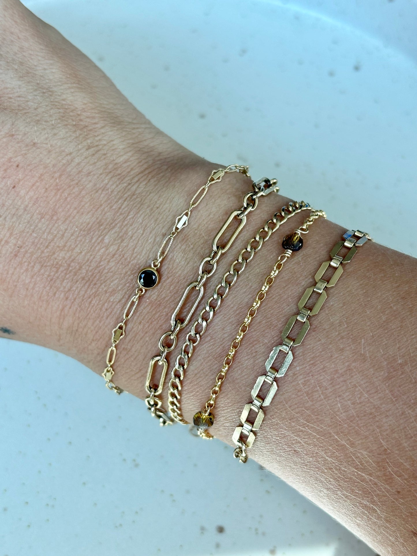 bracelet stack including the olivia bracelet, chanel bracelet, cuban chain and brooke bracelet