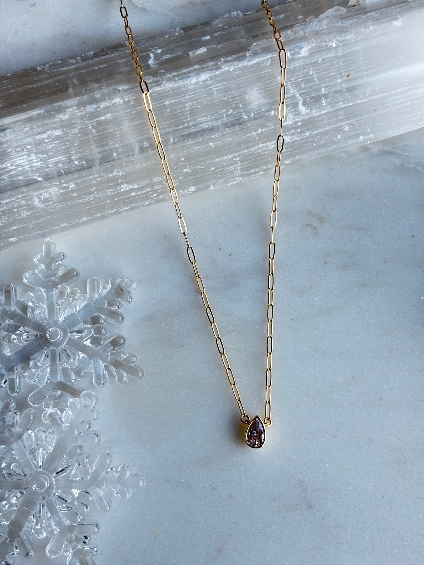 flatlay of the ainsley neckalce on a crystal display
