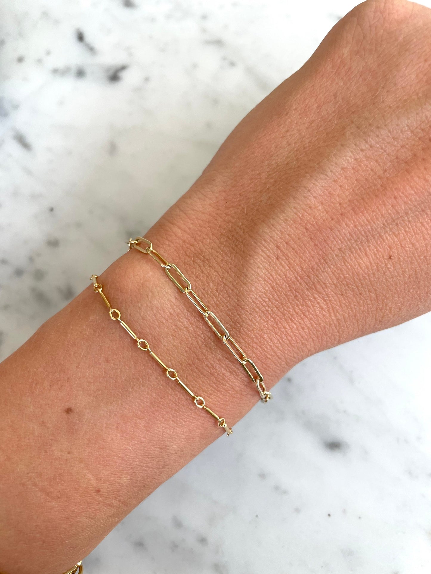 dainty gold filled bar bracelet on wrist