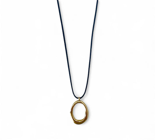 Necklace with a gold pendant on a black cord against a white background