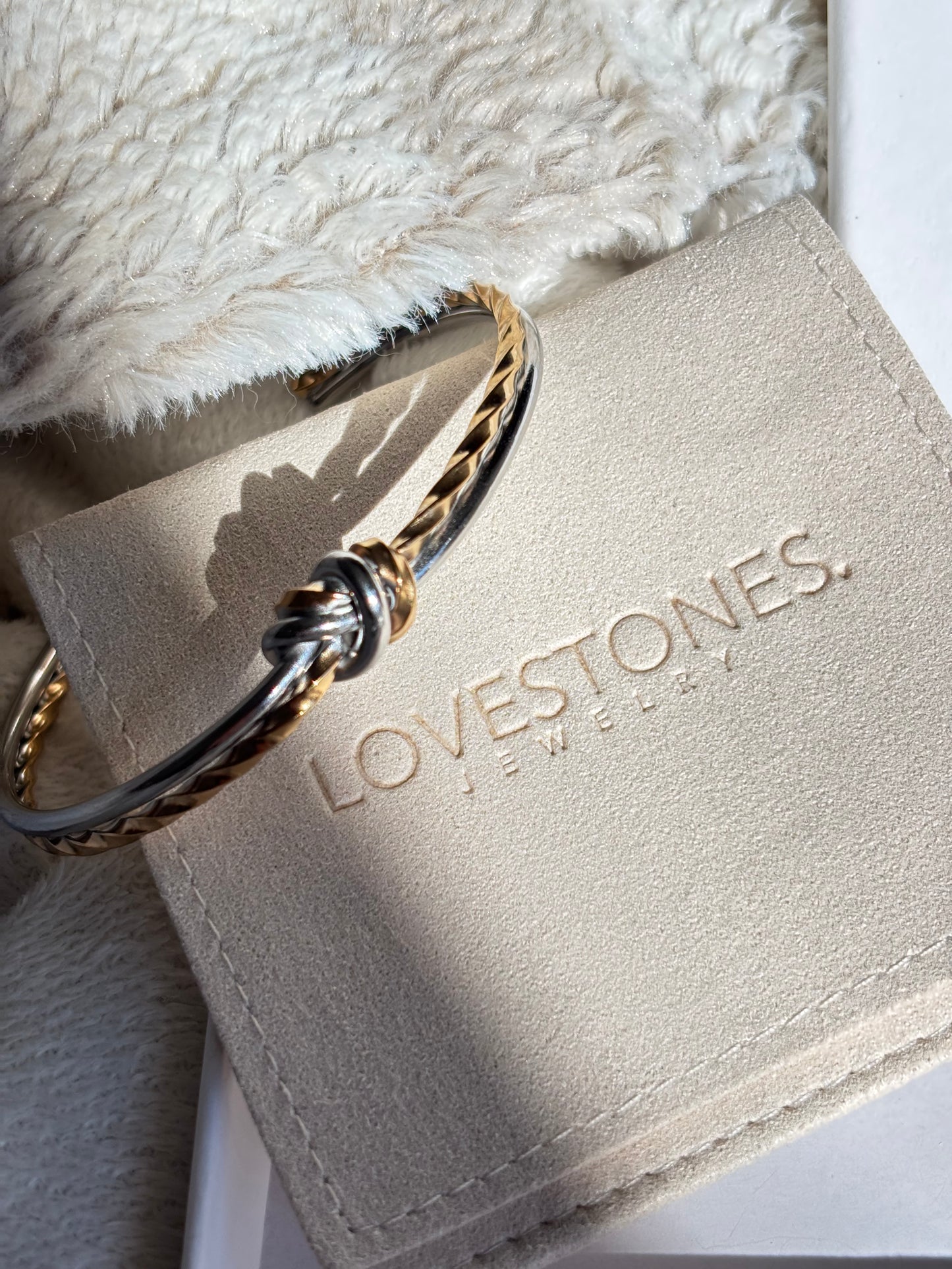 Gold vermeil and stainless steel bracelet on a white box with 'LOVESTONES' branding 