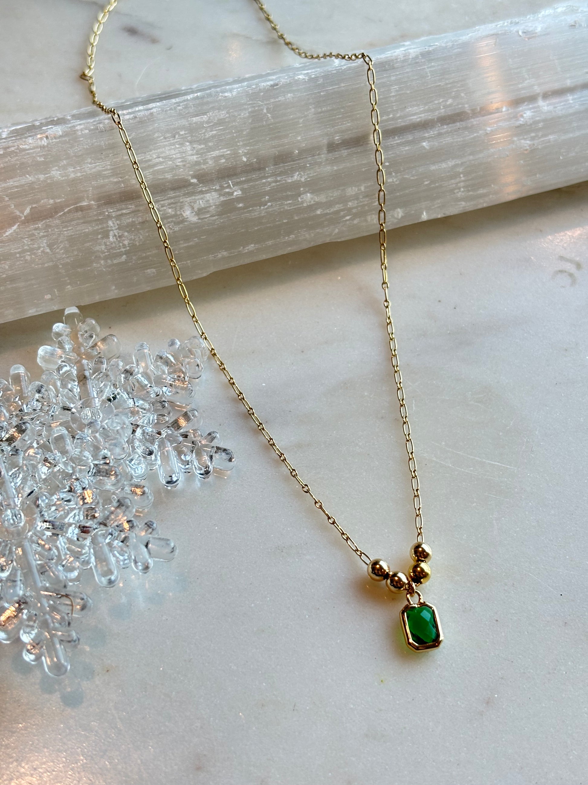 flat lay photo of the anna necklace on a crystal display