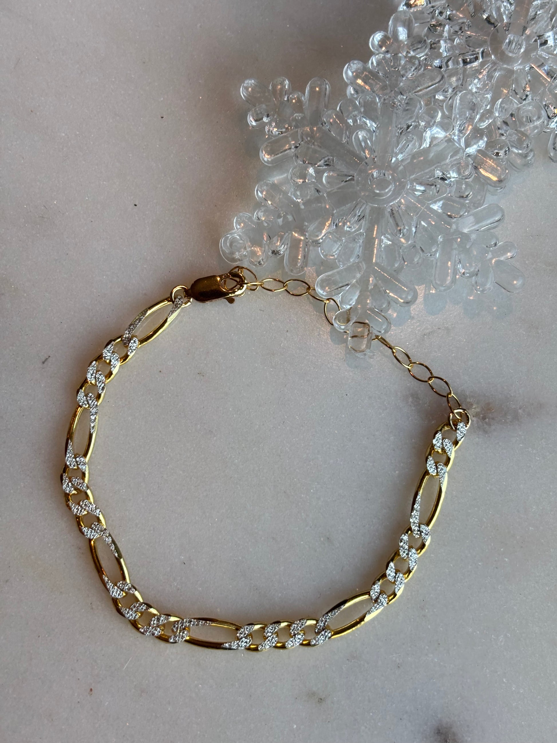 tinsley bracelet next to a clear snowflake