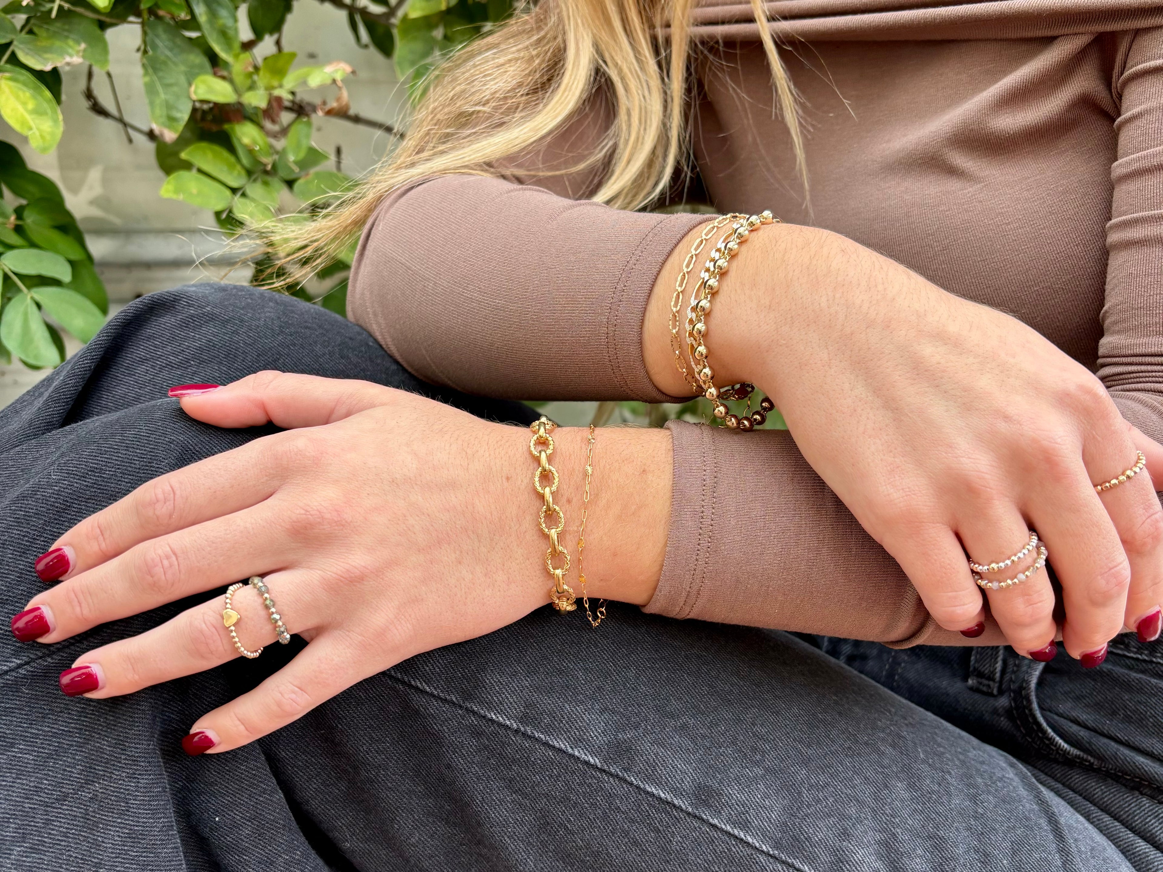 Model wearing  a selection of lovestones bracelets rings and necklaces. 