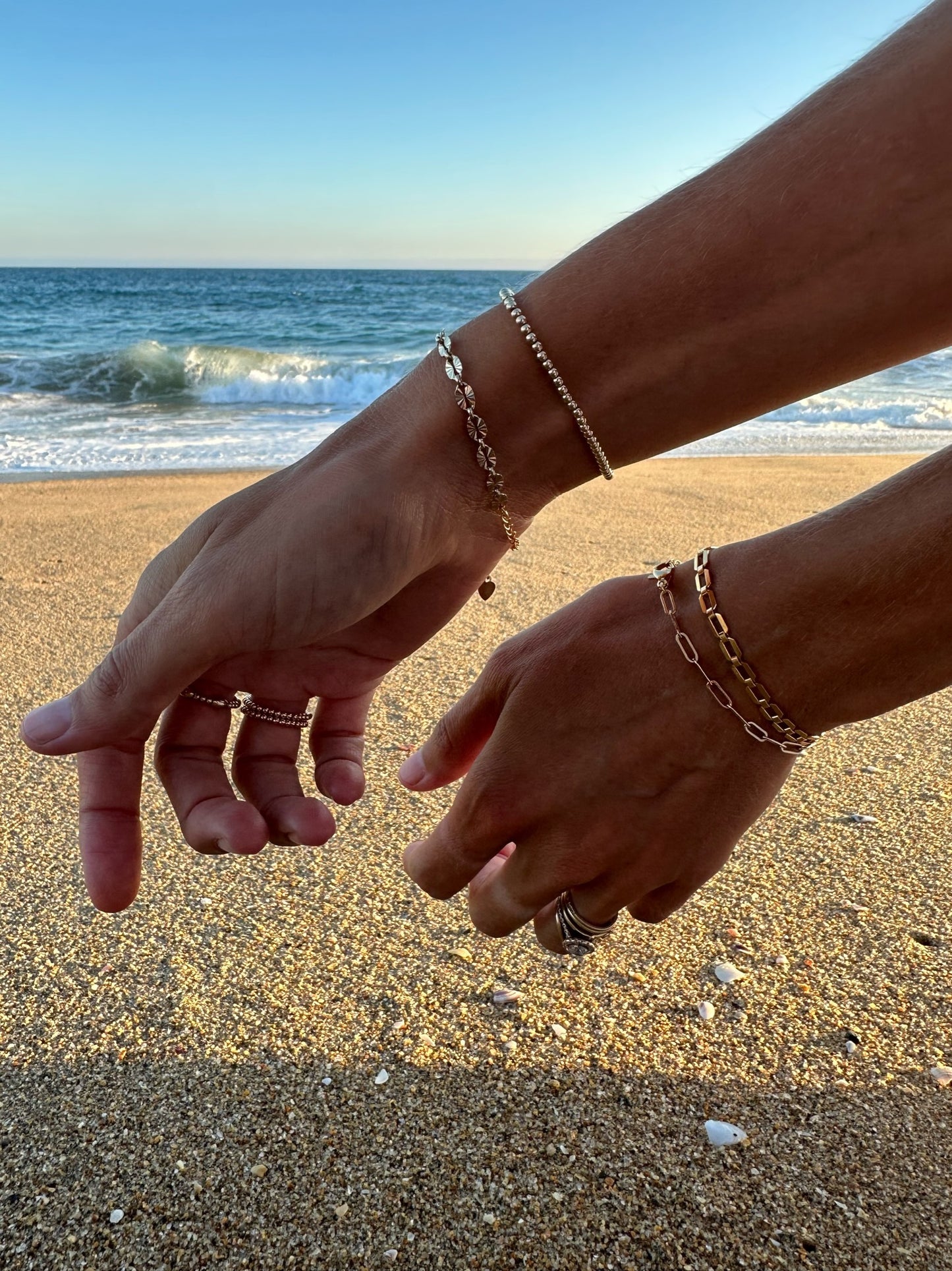 gold filled sunburst chain stack on wrist