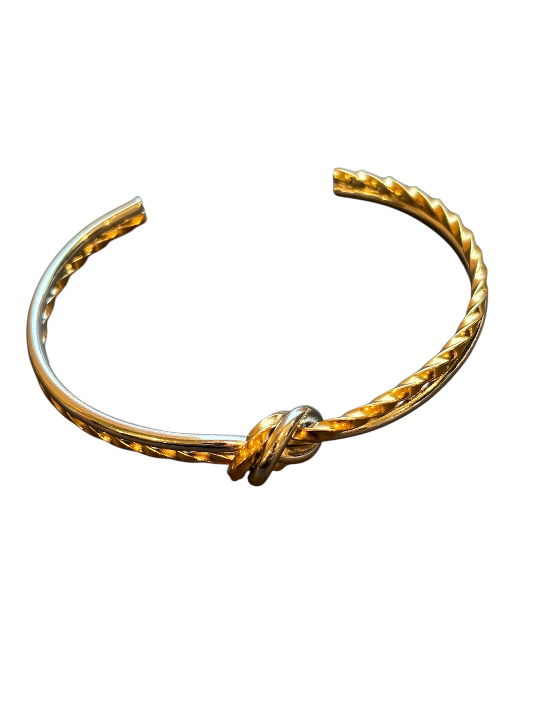 Gold vermeil  and stainless steel bracelet with a knot design on a white background